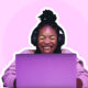 woman on computer with headphones